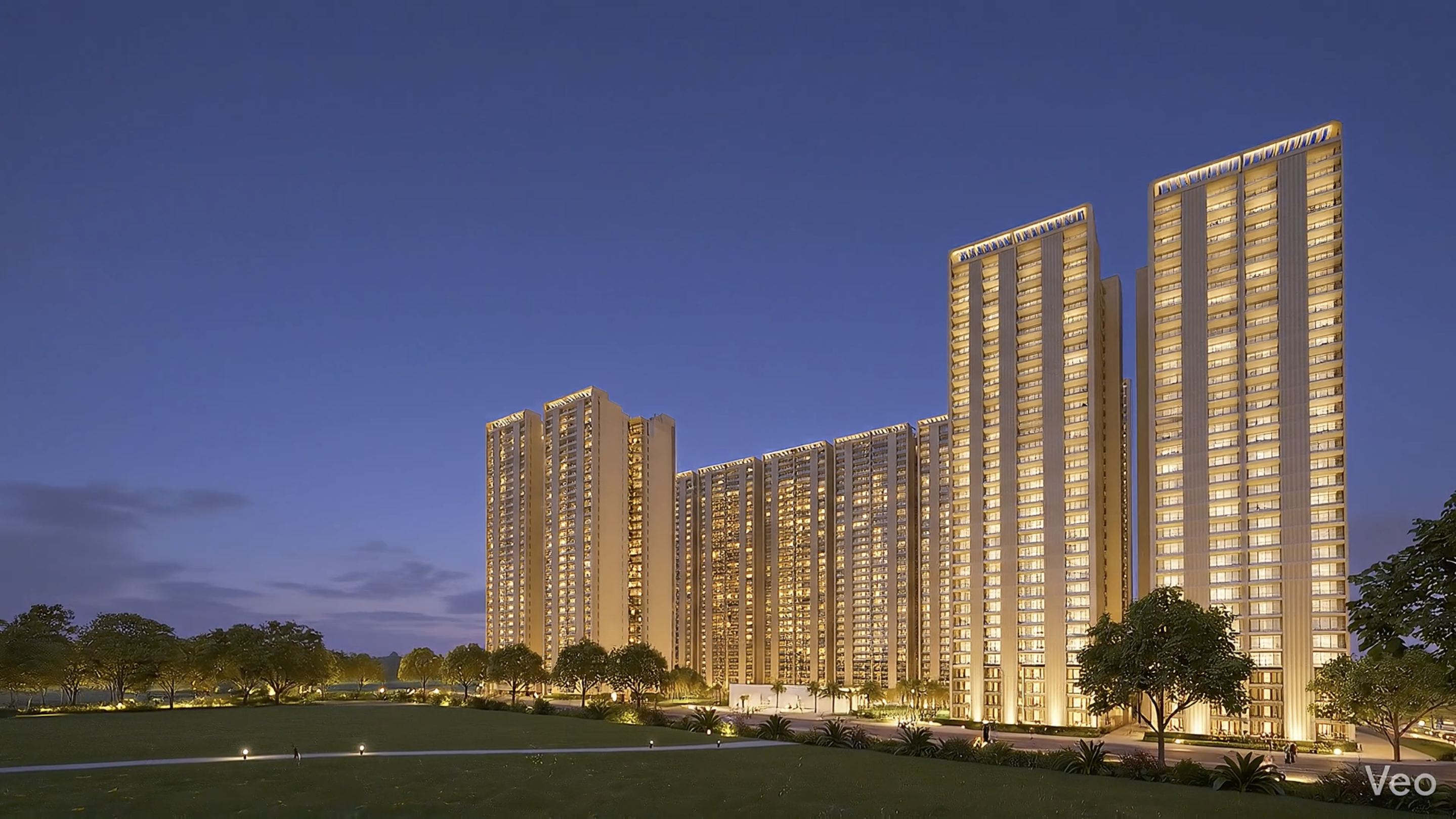 Forbes Fab Luxe Residences towers at dusk with warm golden lighting and landscaped lawns