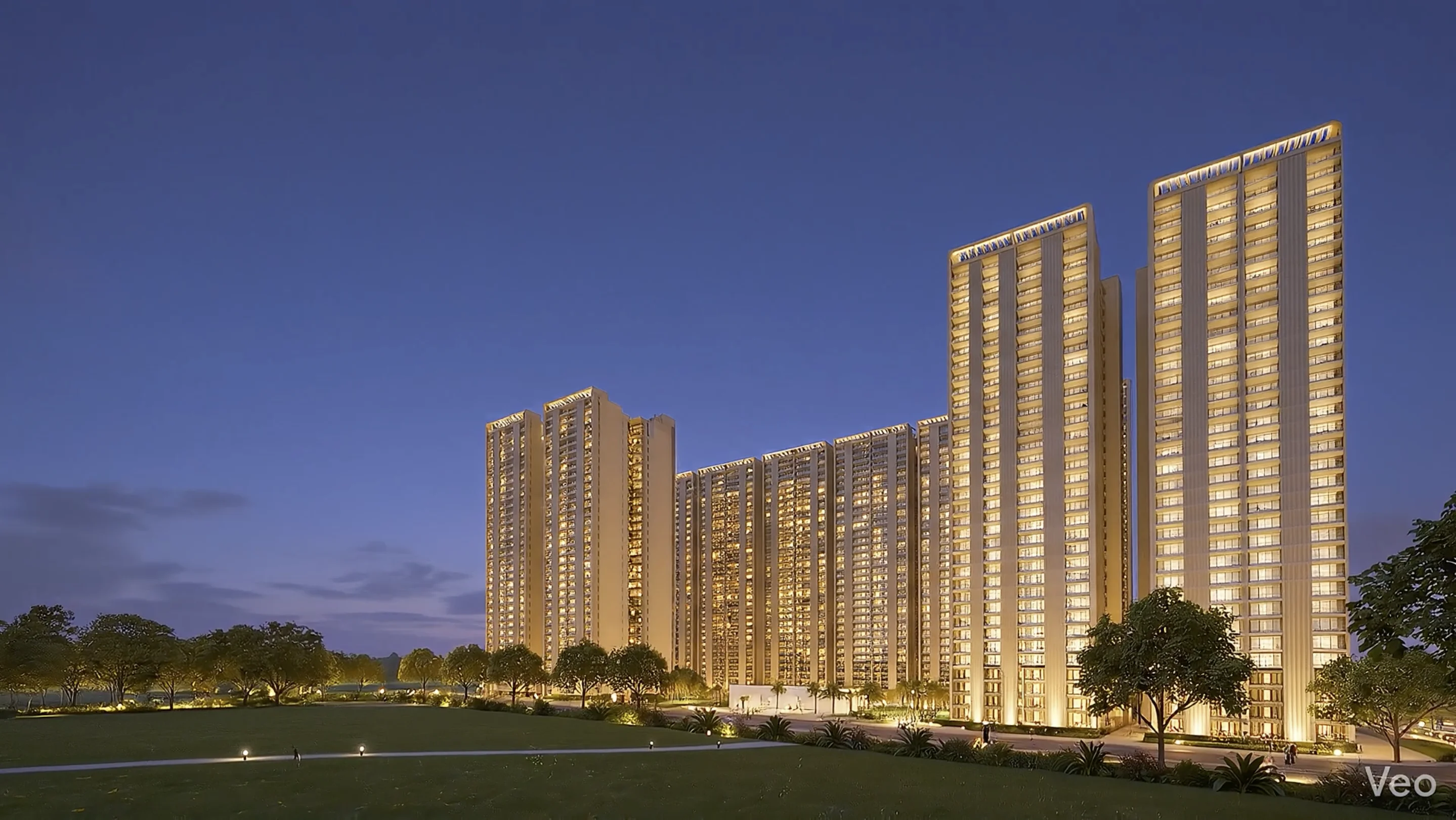 Forbes Fab Luxe Residences towers at dusk with warm golden lighting and landscaped lawns